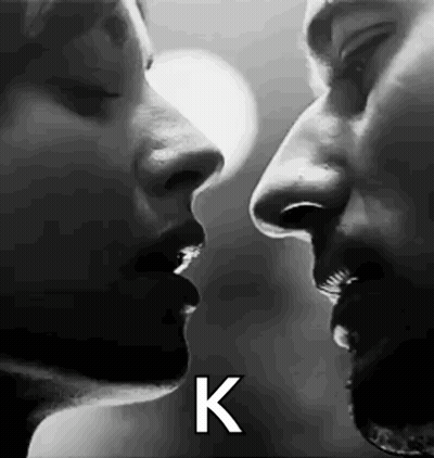 Black and White Photo of Man and Woman Kissing