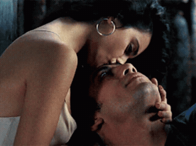 Black And White Photo Of Man And Woman Kissing In Bed GIF