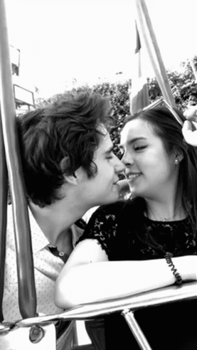 Black And White Photo Of Man And Woman Kissing On Swing GIF