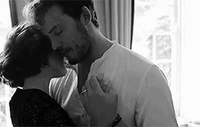 Black And White Photo Of Man And Woman Kissing GIF
