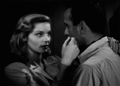 Black And White Photo Of Man And Woman Looking At Each Other GIF