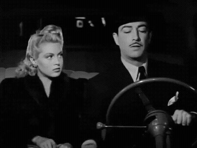 Black And White Photo Of Man And Woman Looking At Each Other GIF