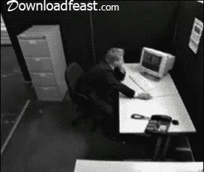 Black And White Photo Of Man At Desk With Downloadfeast.com GIF