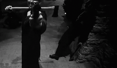 Black And White Photo Of Man Holding Gun GIF