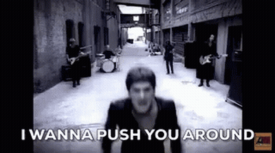 Black And White Photo Of Man In Alleyway With Band GIF
