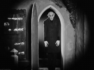 Black And White Photo Of Man In Doorway GIF