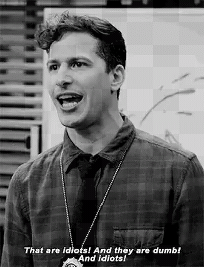 Black and White Photo of Man in Plaid Shirt and Tie Talking