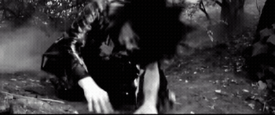 Black And White Photo Of Man Kneeling In Dirt GIF