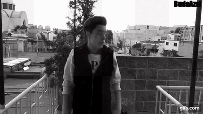 Black And White Photo Of Man On Balcony GIF
