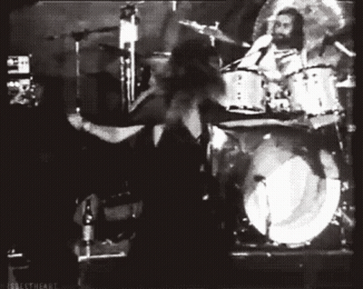 Black And White Photo Of Man Playing Drums In Band GIF