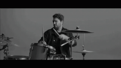 Black And White Photo Of Man Playing Drums GIF