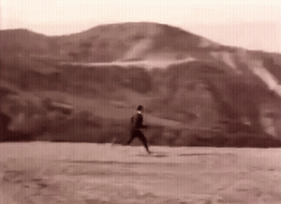 Black And White Photo Of Man Running On Dirt Field GIF