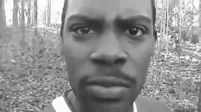 Black And White Photo Of Man's Face In Forest GIF