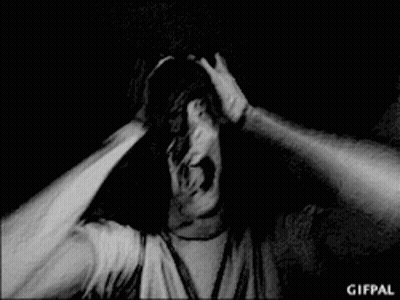 Black and White Photo of Man Screaming With Arms Outstretched