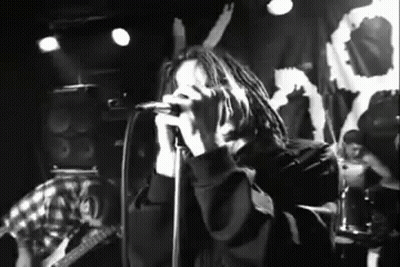 Black And White Photo Of Man Singing Into Microphone GIF