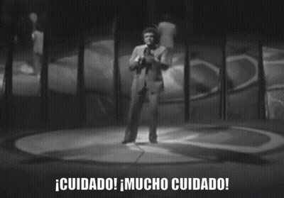 Black And White Photo Of Man Singing Into Microphone Cuidado Mucho Cuidado GIF