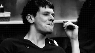 Black And White Photo Of Man Smoking Cigarette In Restaurant GIF