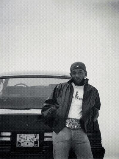Black And White Photo Of Man Standing In Front Of Car With License Plate Saying X GIF