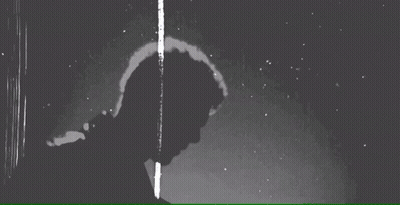 Black And White Photo Of Man Standing In Rain Looking Down GIF