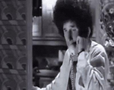 Black And White Photo Of Man Talking On Telephone GIF