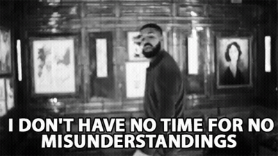 Black And White Photo Of Man With Beard In Front Of Picture Wall GIF