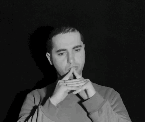 Black And White Photo Of Man With Hands On Chin GIF