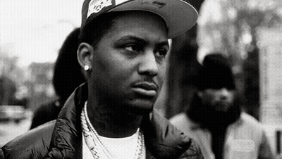 Black And White Photo Of Man With Hat And Necklace GIF