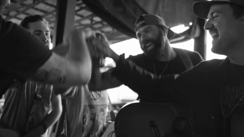 Black And White Photo Of Man With I Play Tattoo GIF