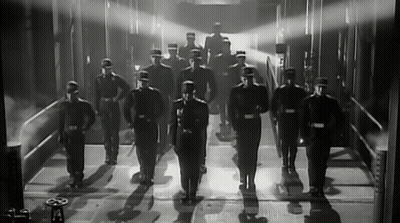 Black And White Photo Of Men In Uniforms GIF