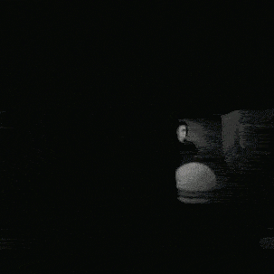 Black and White Photo of People in Dark Room