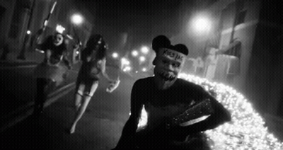 Black And White Photo Of People Wearing Masks GIF