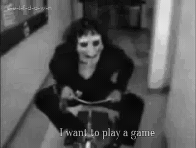 Black And White Photo Of Person In Mask Riding Bicycle GIF