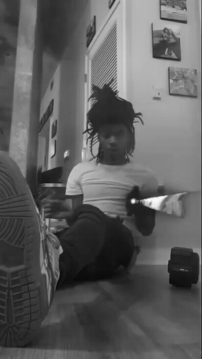 Black And White Photo Of Person Sitting In Hallway GIF