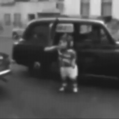 Black And White Photo Of Person Standing In Front Of Car GIF