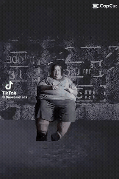 Black And White Photo Of Person Standing On Table In Dark GIF