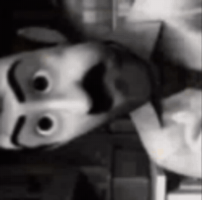 Black And White Photo Of Person Wearing Smiley Face Mask GIF