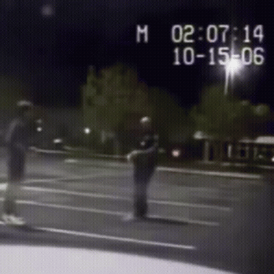 Black And White Photo Of Police Officer And Man On Street GIF