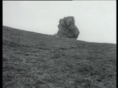 Black And White Photo Of Rock In Grassy Field GIF