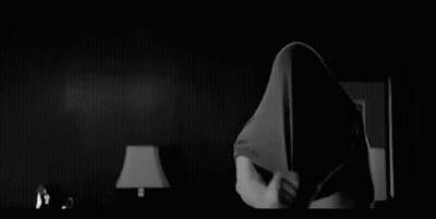 Black and White Photo of Shirtless Man Standing in Room