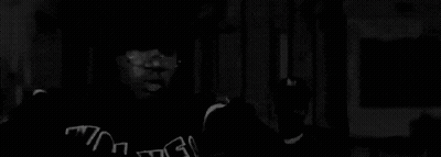 Black And White Photo Of Two Dogs On Sidewalk GIF