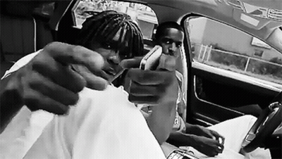 Black And White Photo Of Two Men In A Car GIF