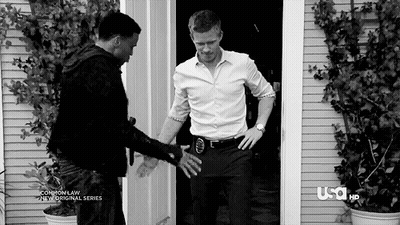 Black And White Photo Of Two Men In Front Of A Door GIF