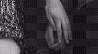 Black And White Photo Of Two People Holding Hands GIF
