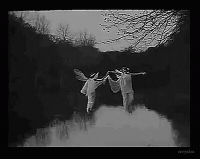 Black And White Photo Of Two People Holding Hands In River GIF