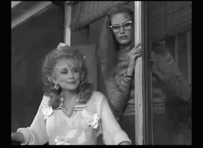 Black And White Photo Of Two Women Standing Together GIF