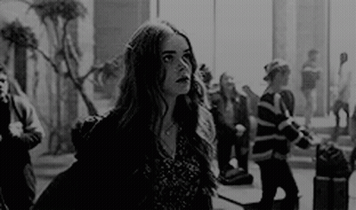 Black And White Photo Of Woman At Airport Window GIF