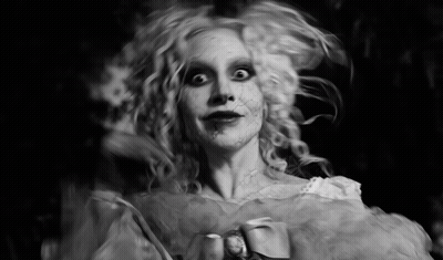 Black And White Photo Of Woman Dressed As Ghost GIF