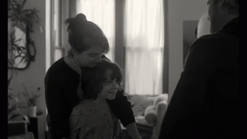 Black And White Photo Of Woman Holding Child GIF