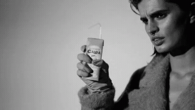 Black And White Photo Of Woman Holding Juice Box GIF