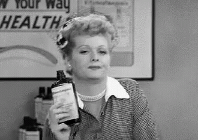 Black And White Photo Of Woman Holding Lotion GIF